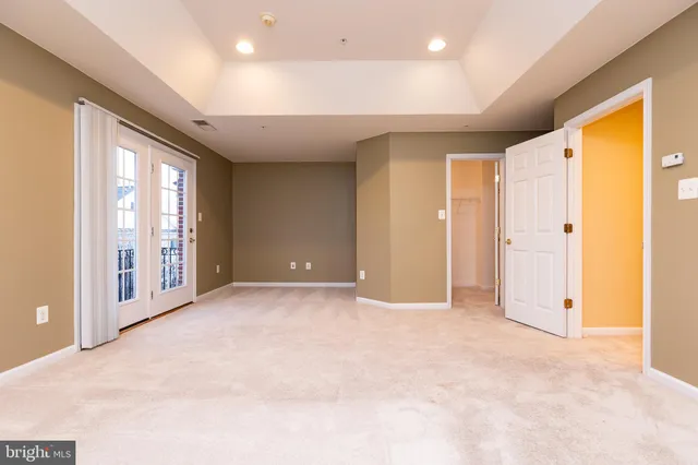 a view of an empty room with glass door and balcony