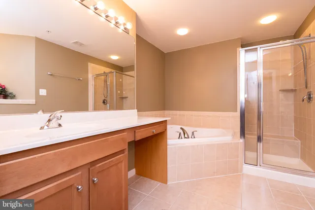 a bathroom with a tub sink and mirror