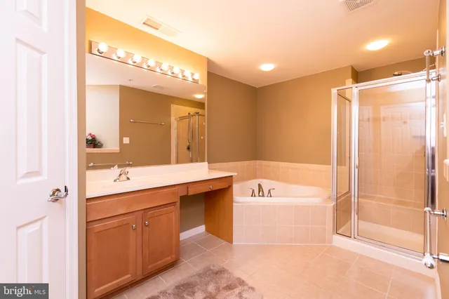 a spacious bathroom with a shower a sink and a bathtub