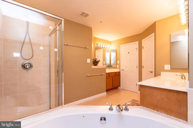 a bathroom with a tub sink and shower