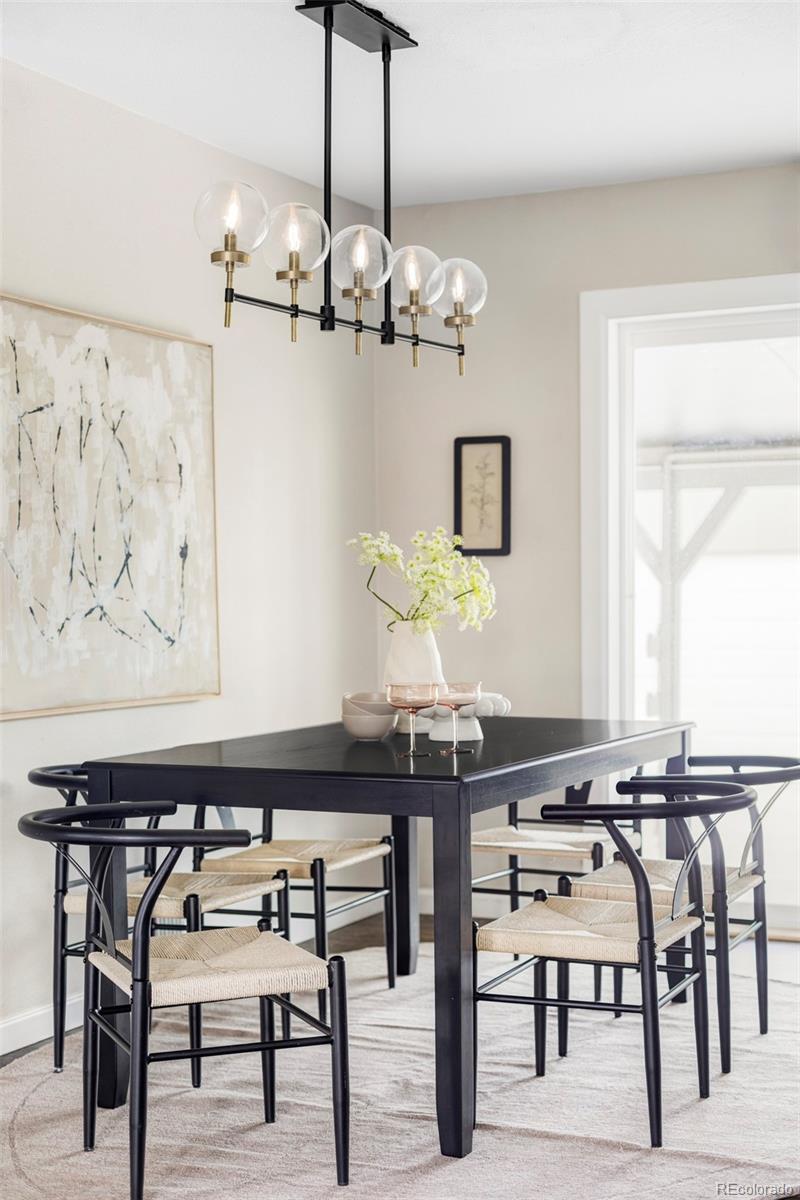 3406 South Stuart Street Denver, CO 80236 - Photo 11 of 34 a view of a dining room with furniture and chandelier