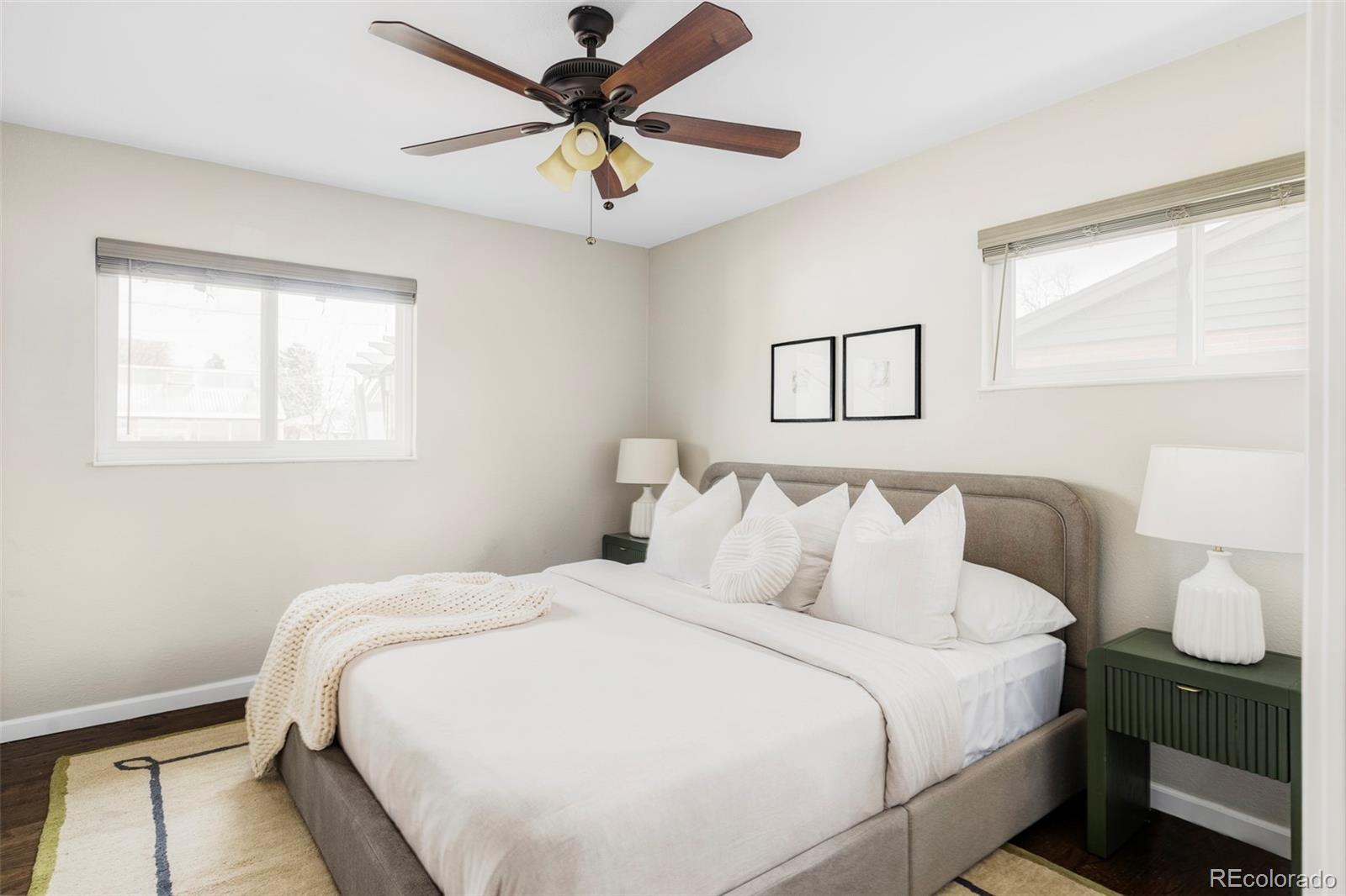 3406 South Stuart Street Denver, CO 80236 - Photo 14 of 34 a bedroom with a large bed and a window