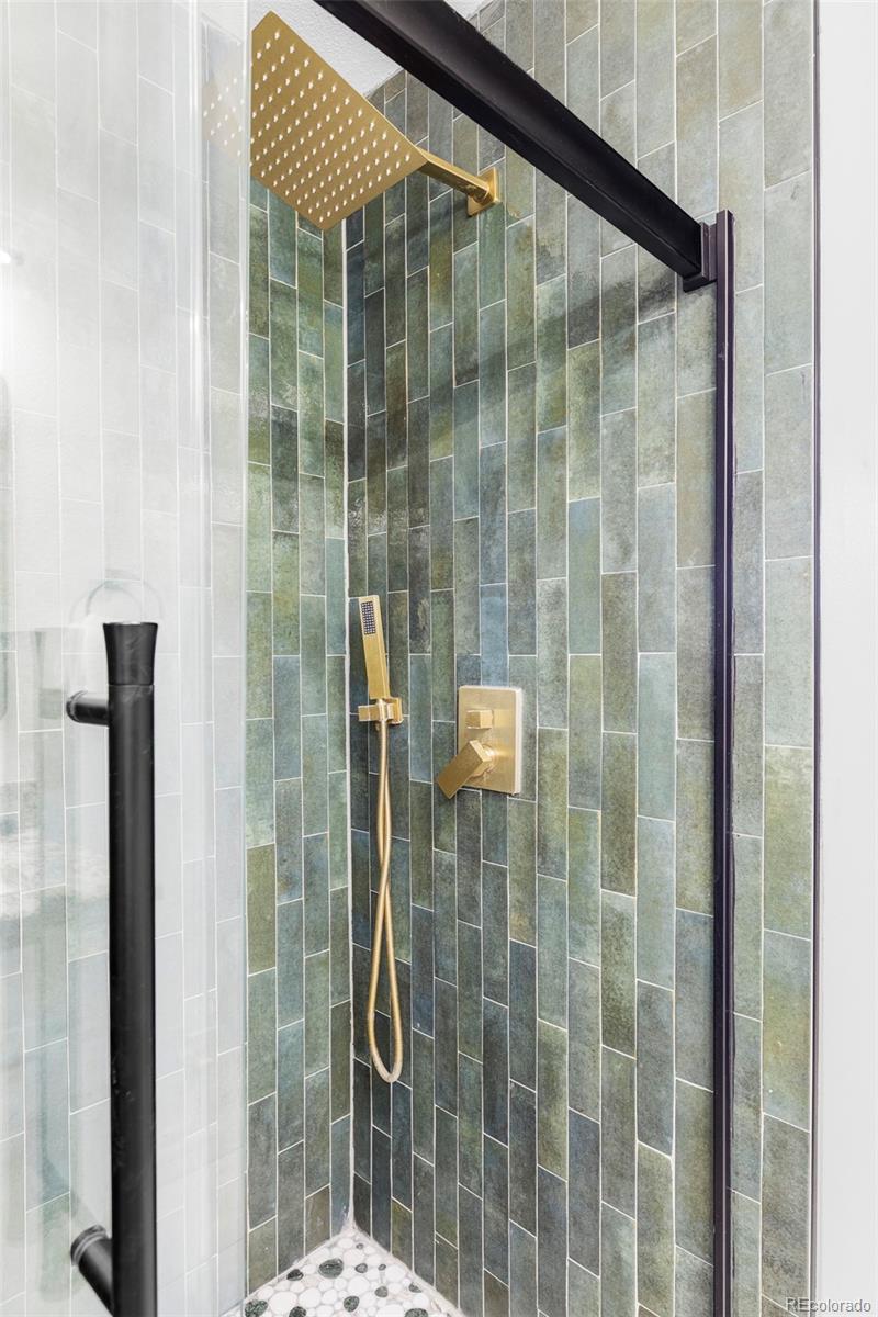 3406 South Stuart Street Denver, CO 80236 - Photo 18 of 34 a bathroom with a shower