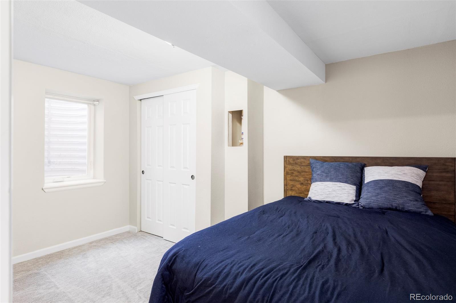3406 South Stuart Street Denver, CO 80236 - Photo 27 of 34 a bedroom with a bed and a window