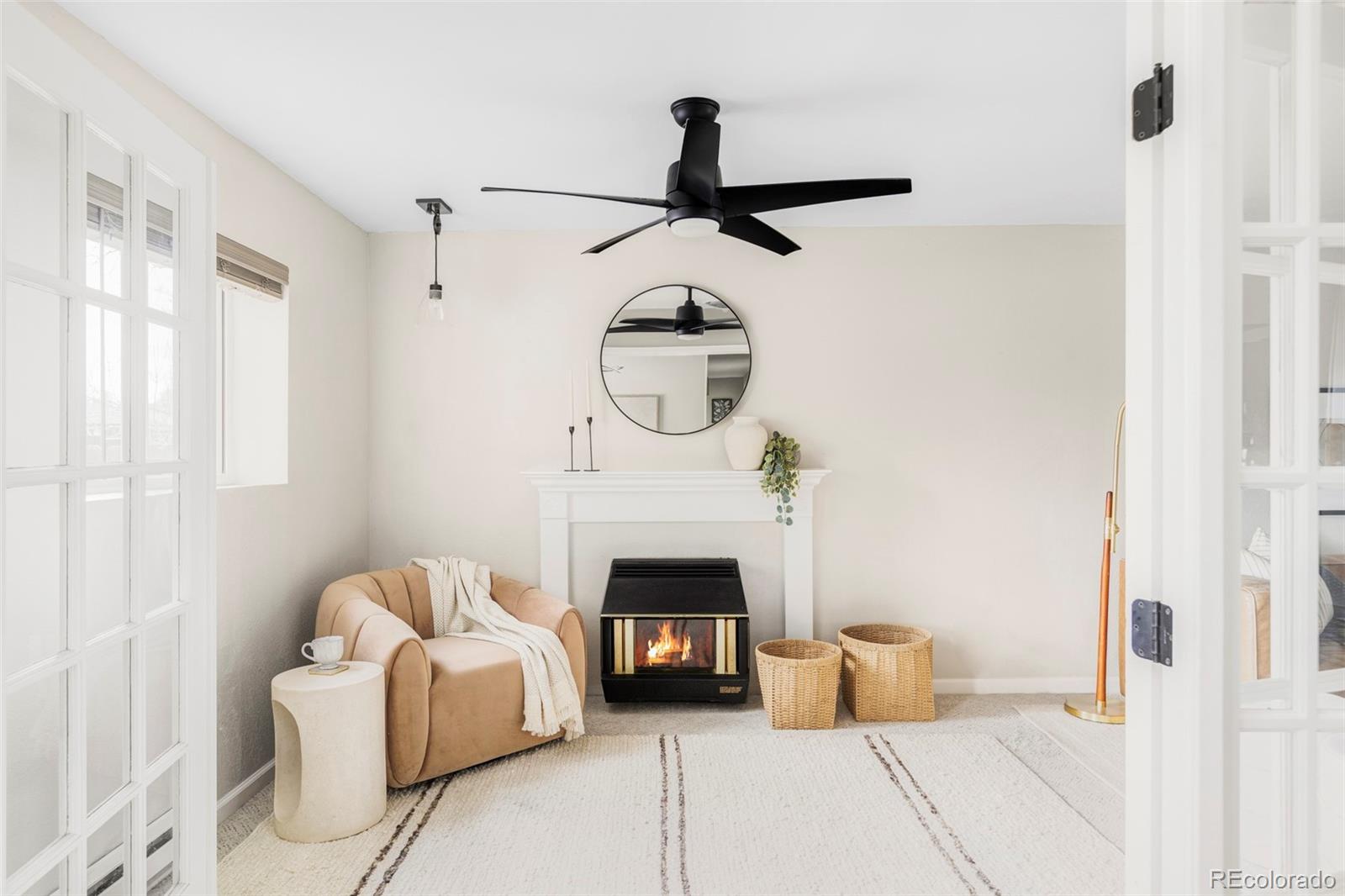 3406 South Stuart Street Denver, CO 80236 - Photo 5 of 34 a living room with furniture and a fireplace