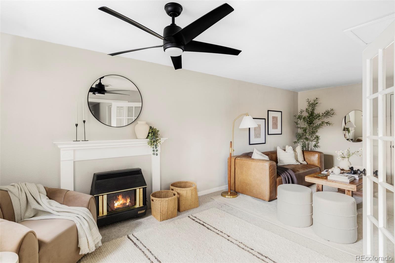 3406 South Stuart Street Denver, CO 80236 - Photo 7 of 34 a living room with furniture a fireplace and flat screen tv