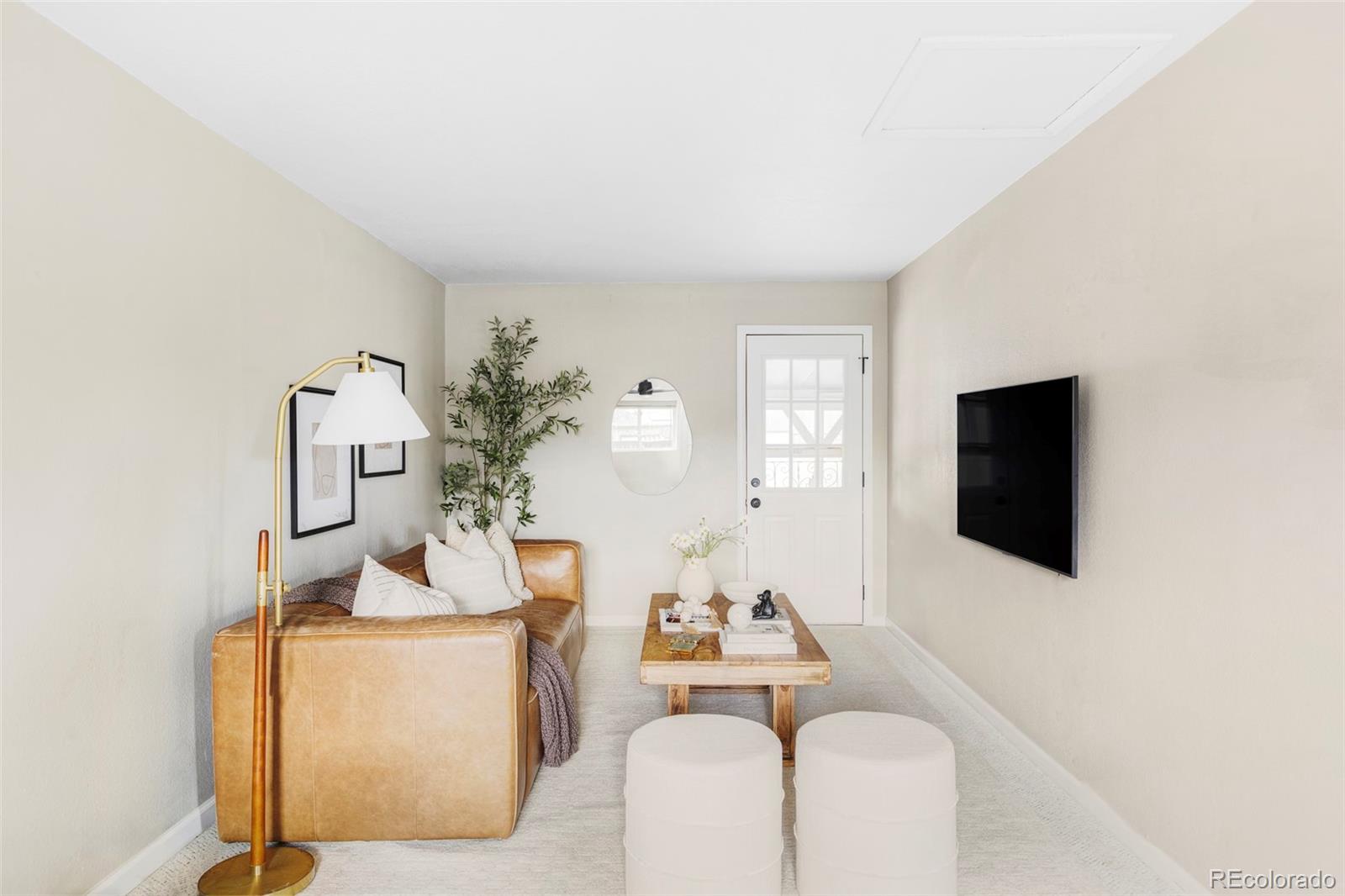 3406 South Stuart Street Denver, CO 80236 - Photo 8 of 34 a living room with furniture and a flat screen tv