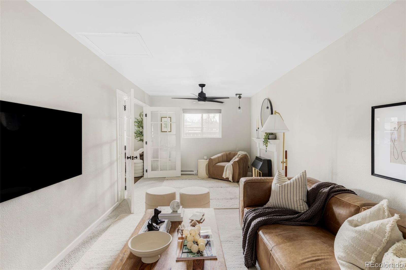 3406 South Stuart Street Denver, CO 80236 - Photo 9 of 34 a living room with furniture and a flat screen tv