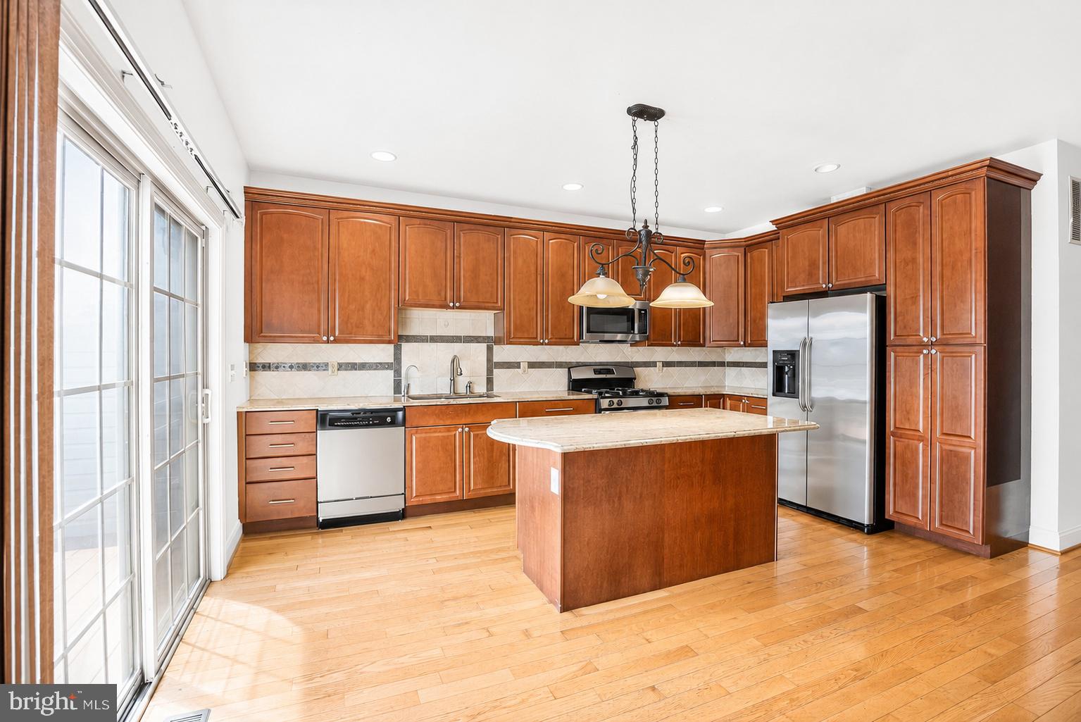 493 Harmon Road, Unit F Philadelphia, PA 19128 - Photo 5 of 38 Modern kitchen with rich wood tones.
