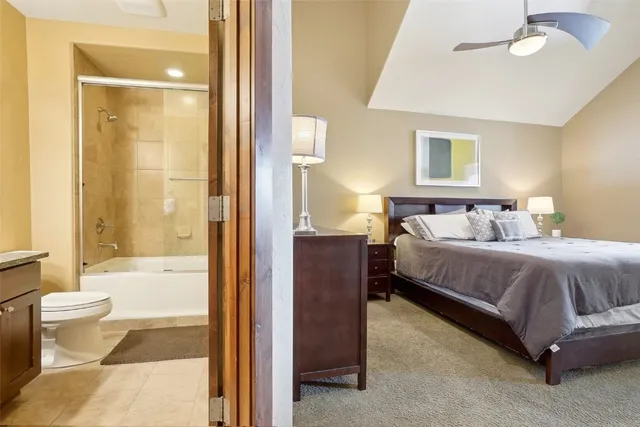 a bedroom with a bed and a glass door shower