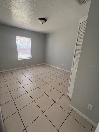 a view of an empty room and a window