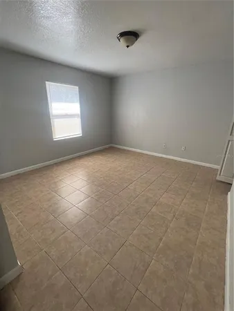 an empty room with windows and entrance