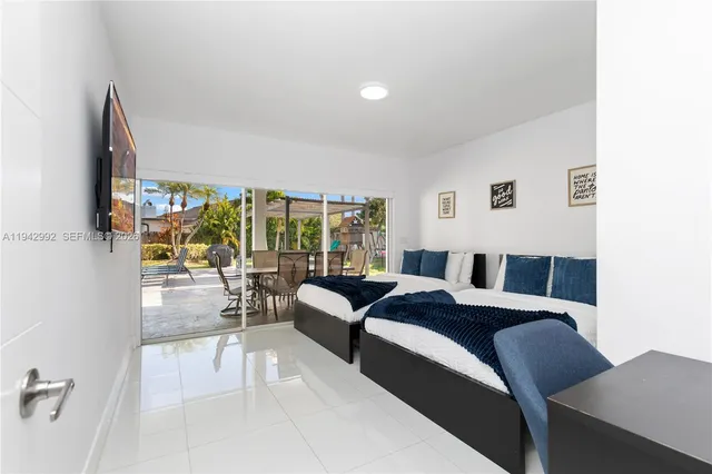 a bedroom with a bed and glass wall