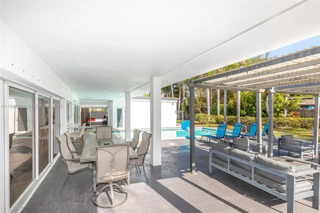 a view of a dining room with furniture large windows and wooden floor