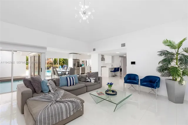 a living room with furniture potted plant and window