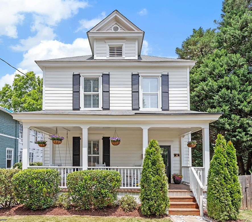 front view of a brick house with a yard