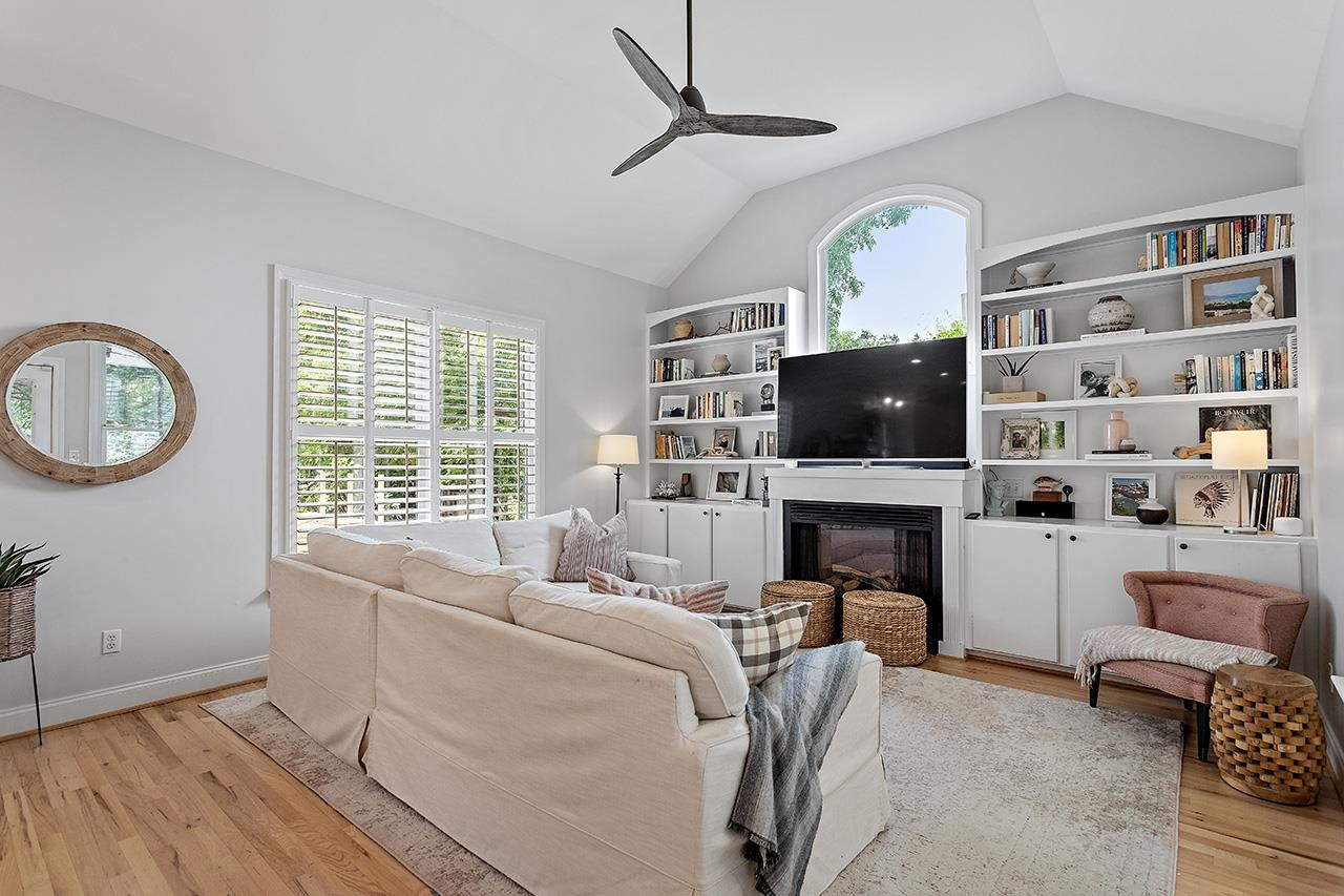 502 Cleveland Street Raleigh, NC 27605 - Photo 11 of 36 a living room with furniture a fireplace and a flat screen tv