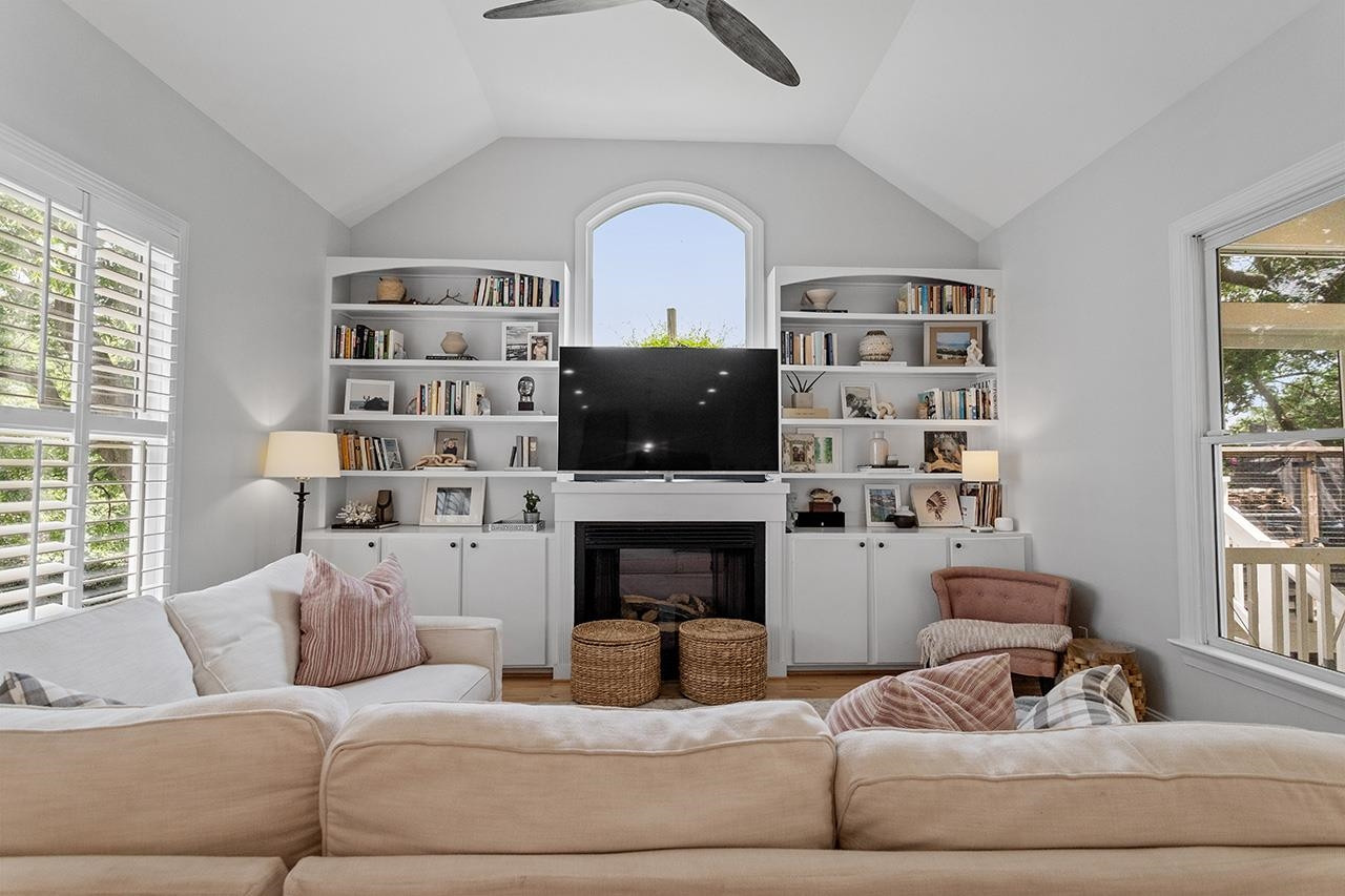 502 Cleveland Street Raleigh, NC 27605 - Photo 12 of 36 a living room with furniture a fireplace and a flat screen tv