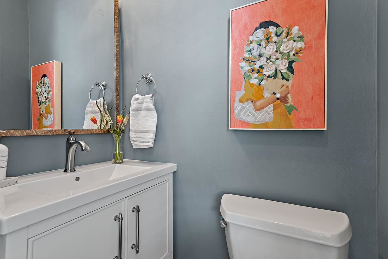 502 Cleveland Street Raleigh, NC 27605 - Photo 15 of 36 a bathroom with a toilet sink and mirror