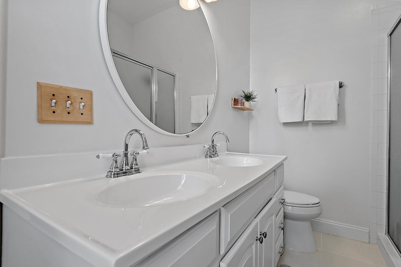502 Cleveland Street Raleigh, NC 27605 - Photo 17 of 36 a bathroom with a sink a toilet and mirror