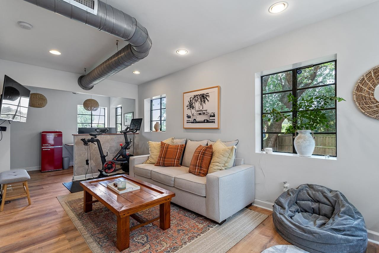 502 Cleveland Street Raleigh, NC 27605 - Photo 25 of 36 a living room with furniture a rug and a window