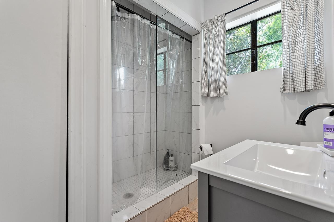 502 Cleveland Street Raleigh, NC 27605 - Photo 28 of 36 a bathroom with a sink and a shower