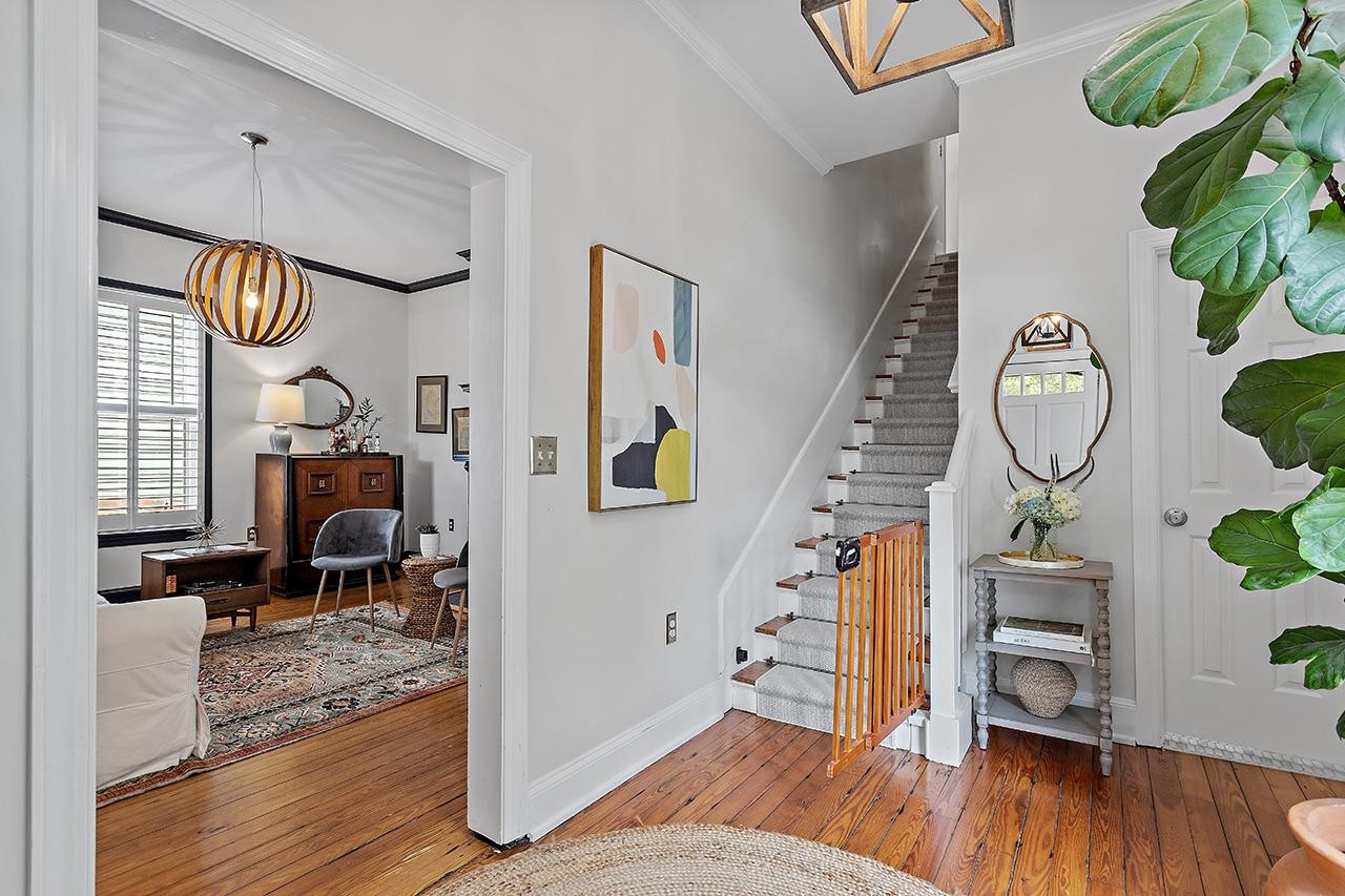 502 Cleveland Street Raleigh, NC 27605 - Photo 3 of 36 a bedroom with furniture and a wooden floor