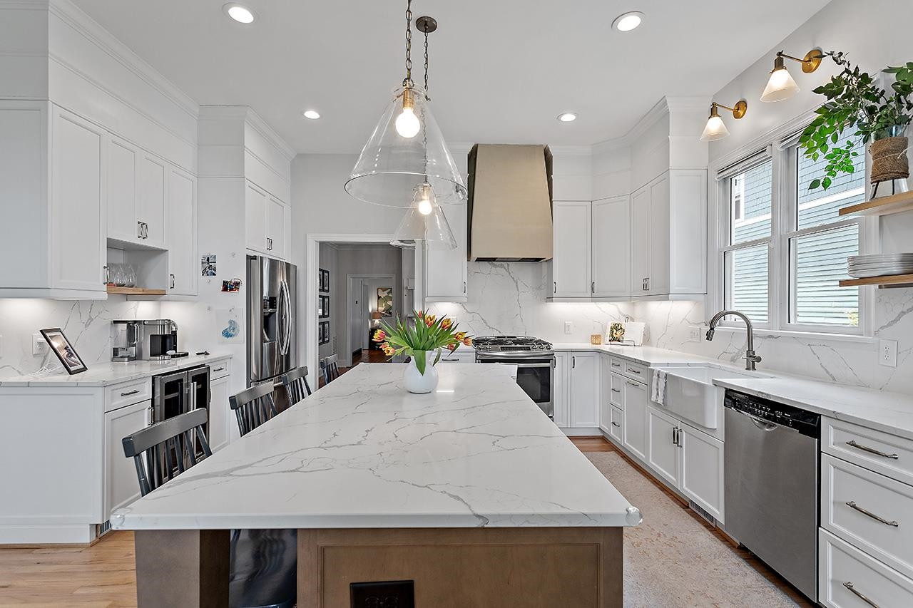 502 Cleveland Street Raleigh, NC 27605 - Photo 8 of 36 a large kitchen with kitchen island a sink stainless steel appliances and cabinets