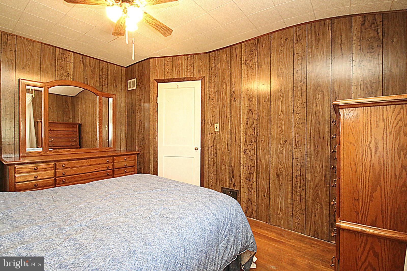 2004 Jasmine Road Baltimore, MD 21222 - Photo 17 of 29 a bedroom with a bed and a chandelier