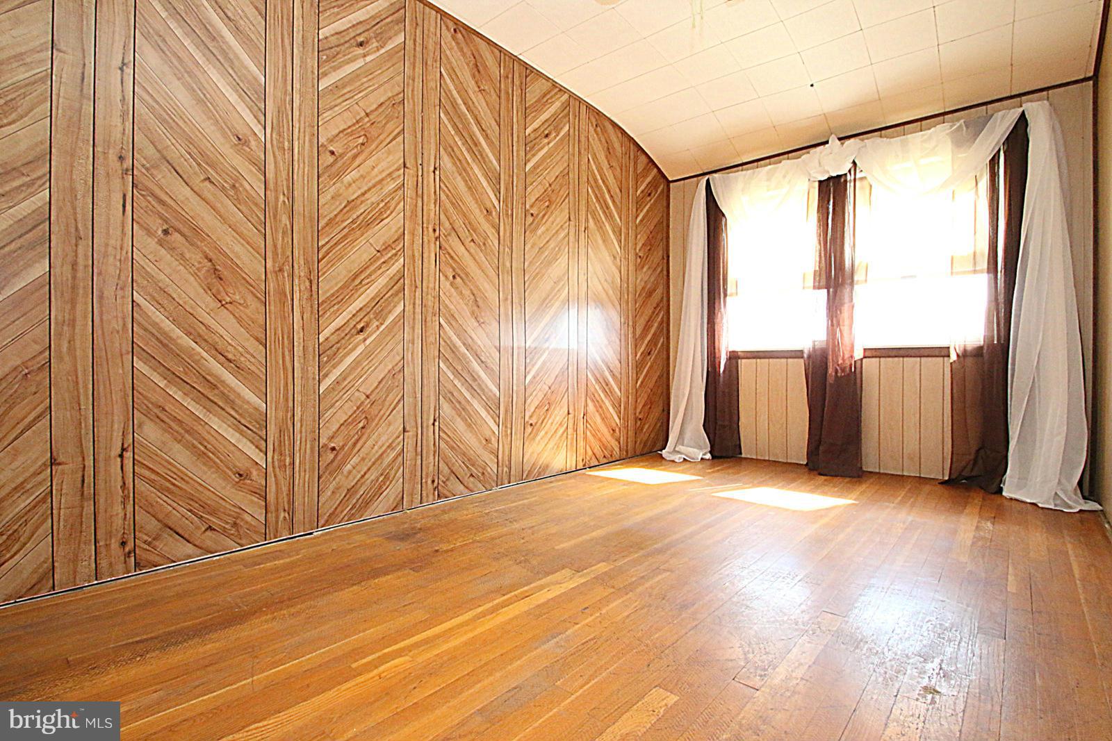 2004 Jasmine Road Baltimore, MD 21222 - Photo 20 of 29 a view of an empty room with a window and wooden floor