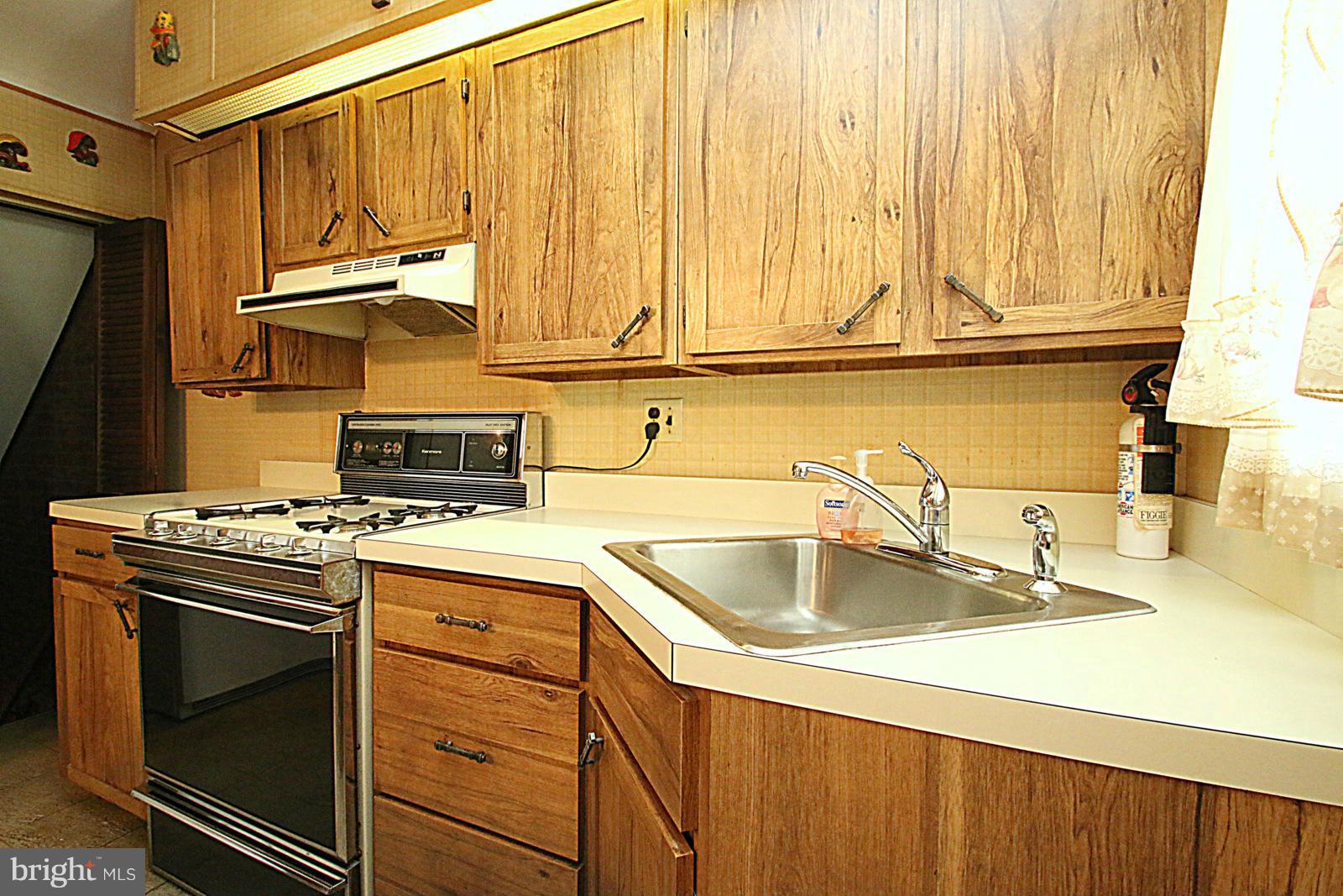 2004 Jasmine Road Baltimore, MD 21222 - Photo 4 of 29 a kitchen with stainless steel appliances granite countertop a sink and a stove