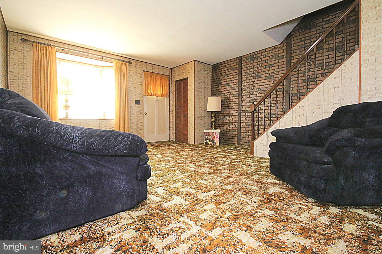 2004 Jasmine Road Baltimore, MD 21222 - Photo 6 of 29 a living room with a couch and a large window