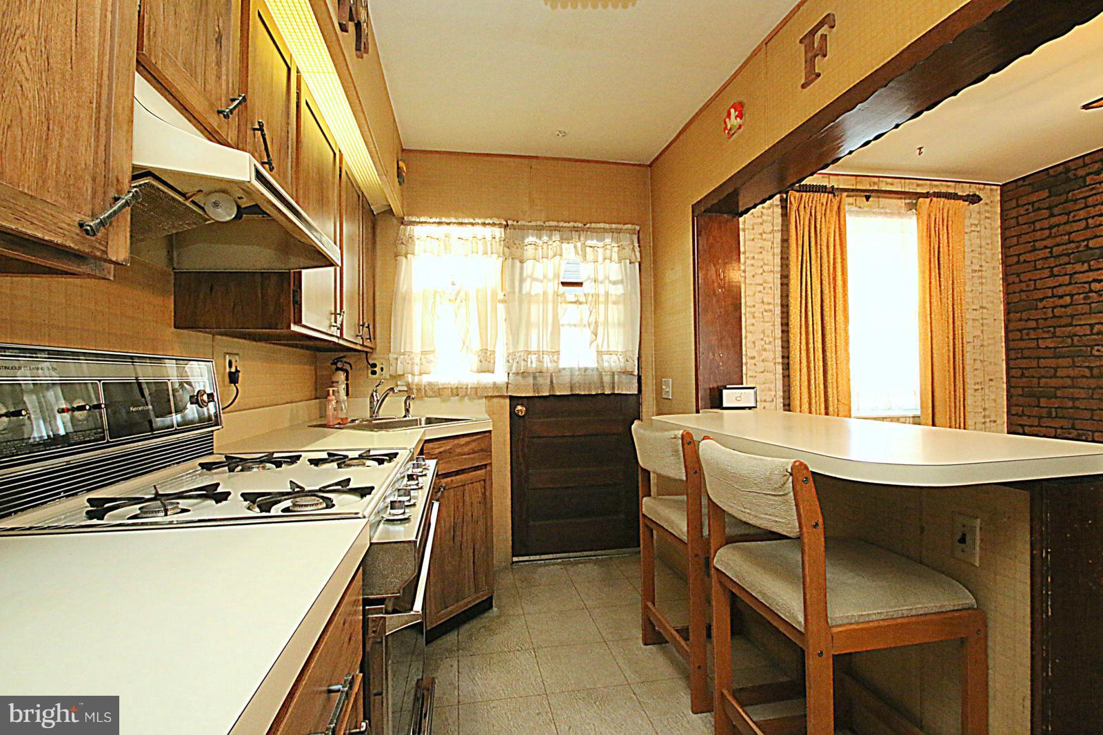 2004 Jasmine Road Baltimore, MD 21222 - Photo 7 of 29 a kitchen with a stove a sink and a refrigerator