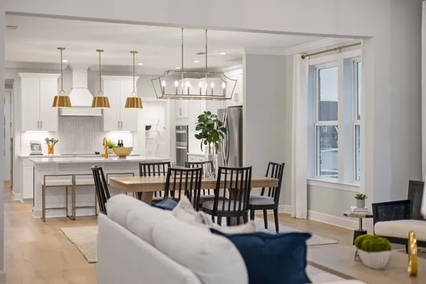 a view of a dining room with furniture kitchen and chandelier