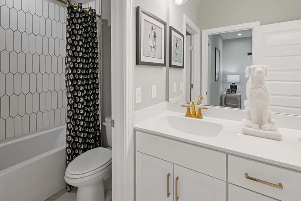 a bathroom with a sink a toilet and a tub