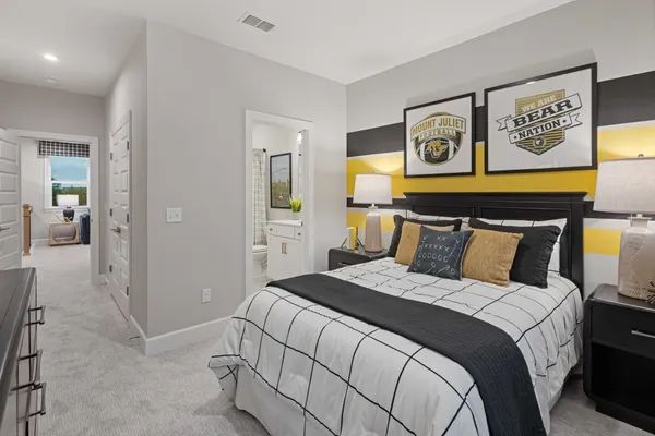 a bedroom with a bed and painting on the wall