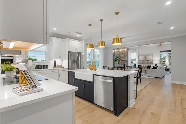 a view of kitchen with kitchen island stainless steel appliances kitchen island a stove a sink a center island and a refrigerator