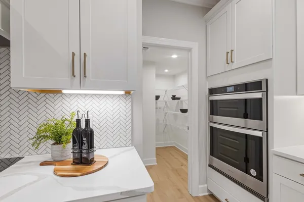 a kitchen with a sink and stove top oven