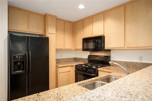 a kitchen with a refrigerator stove and cabinets