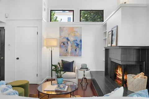 a bedroom with a bed and large window with a rug