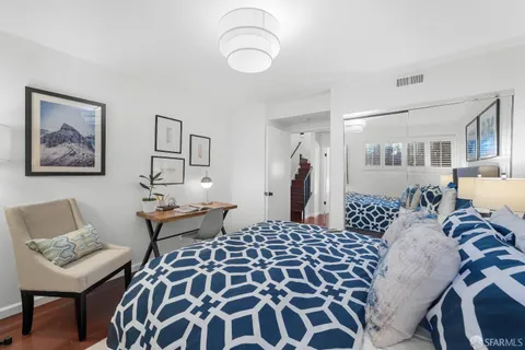 a balcony with wooden floor and outdoor seating