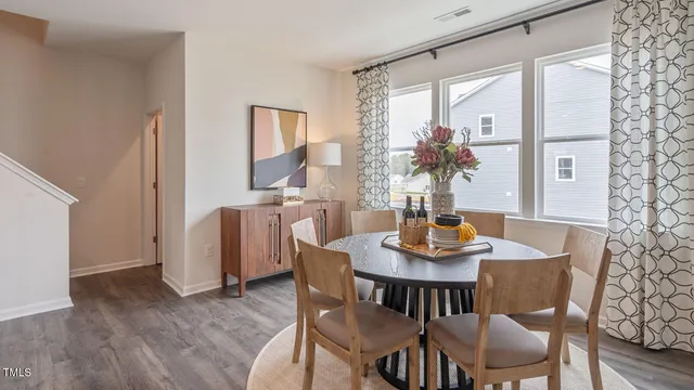 a kitchen with refrigerator a sink and chairs