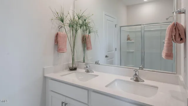 a bathroom with a glass shower door