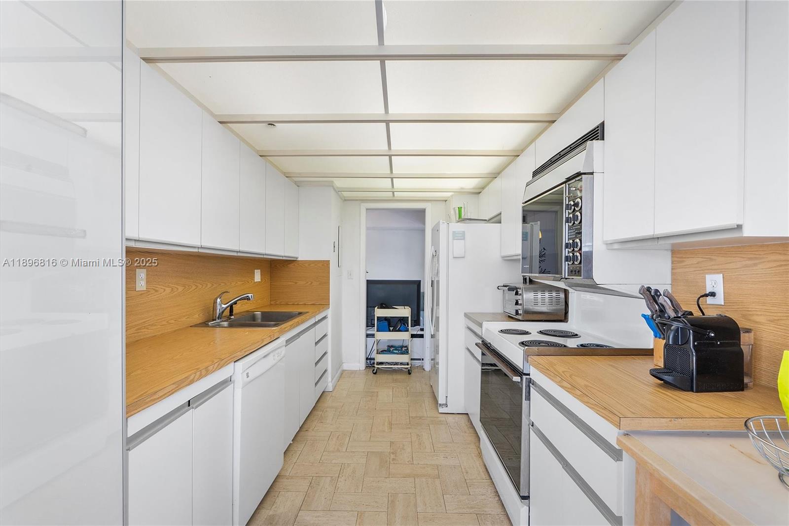 4000 Towerside Terrace, Unit 402 Miami, FL 33138 - Photo 14 of 54 a large kitchen with a sink and dishwasher a stove top oven