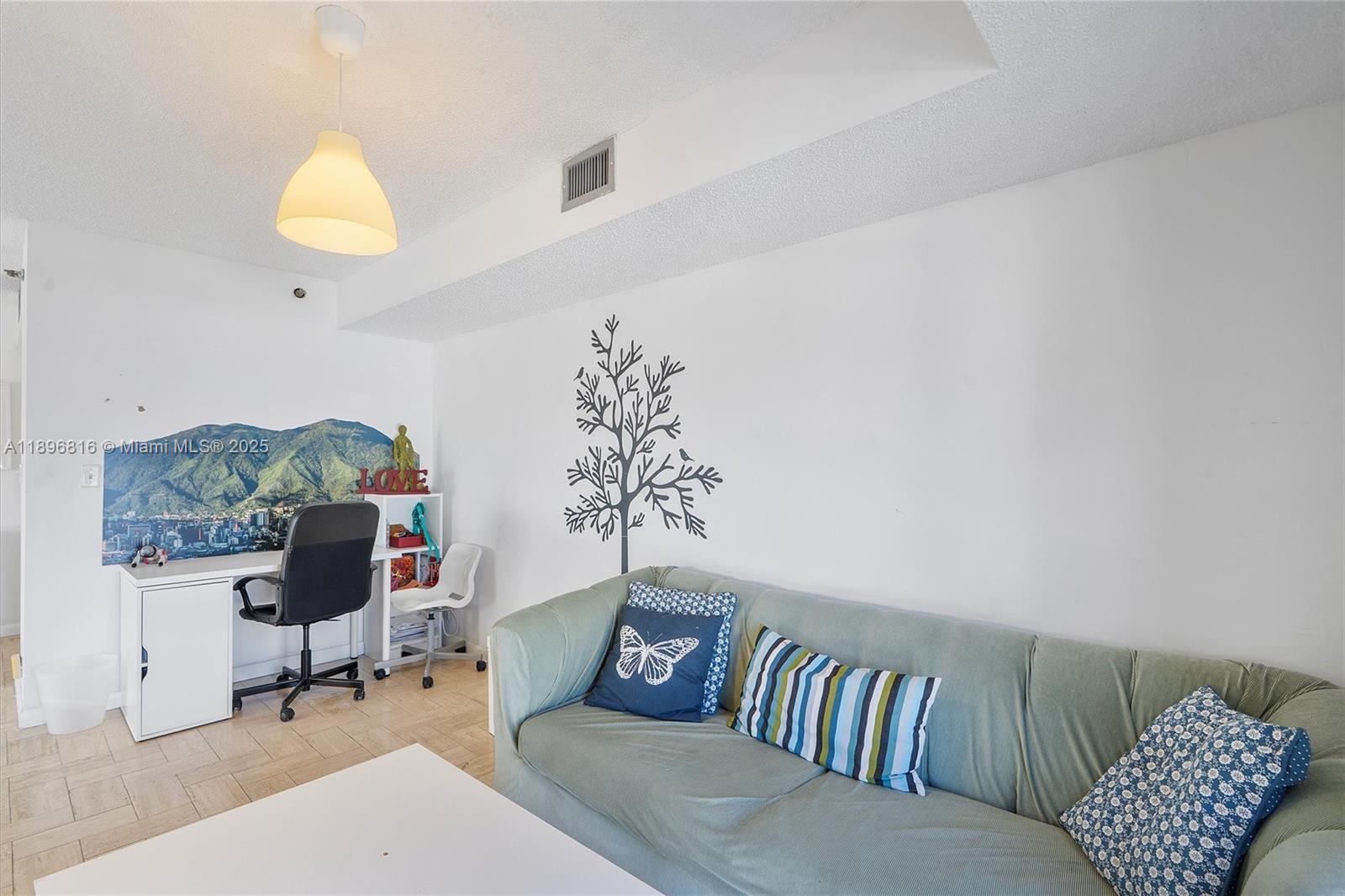 4000 Towerside Terrace, Unit 402 Miami, FL 33138 - Photo 18 of 54 a living room with furniture and a chair