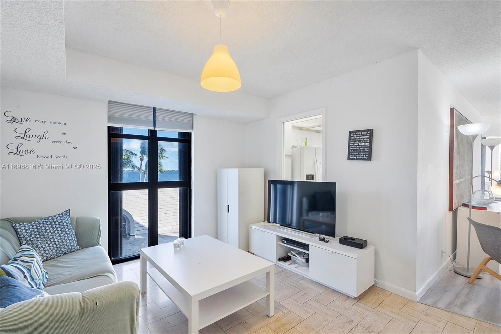 4000 Towerside Terrace, Unit 402 Miami, FL 33138 - Photo 19 of 54 a living room with furniture and a flat screen tv