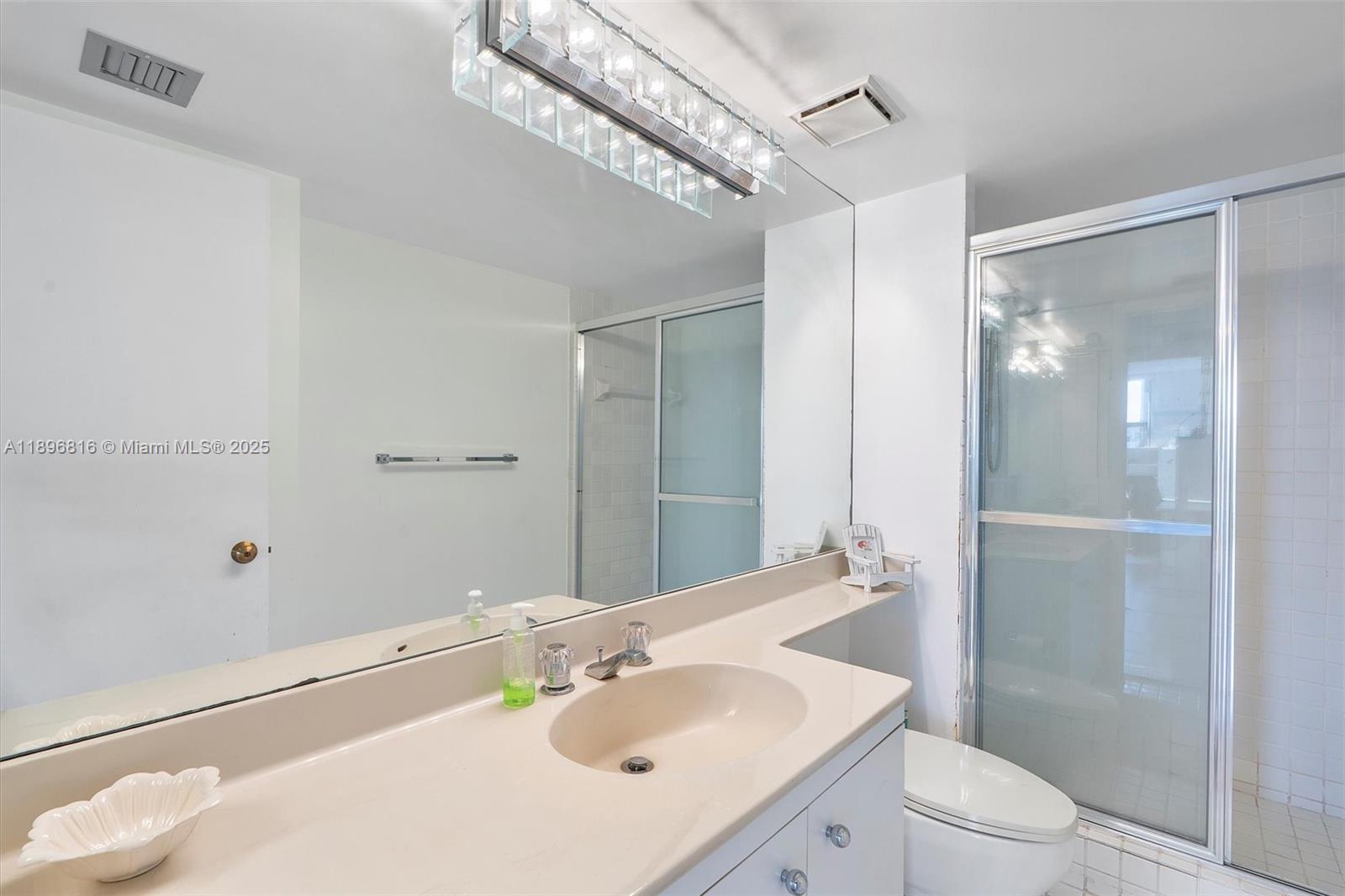 4000 Towerside Terrace, Unit 402 Miami, FL 33138 - Photo 21 of 54 a bathroom with a sink a toilet and shower