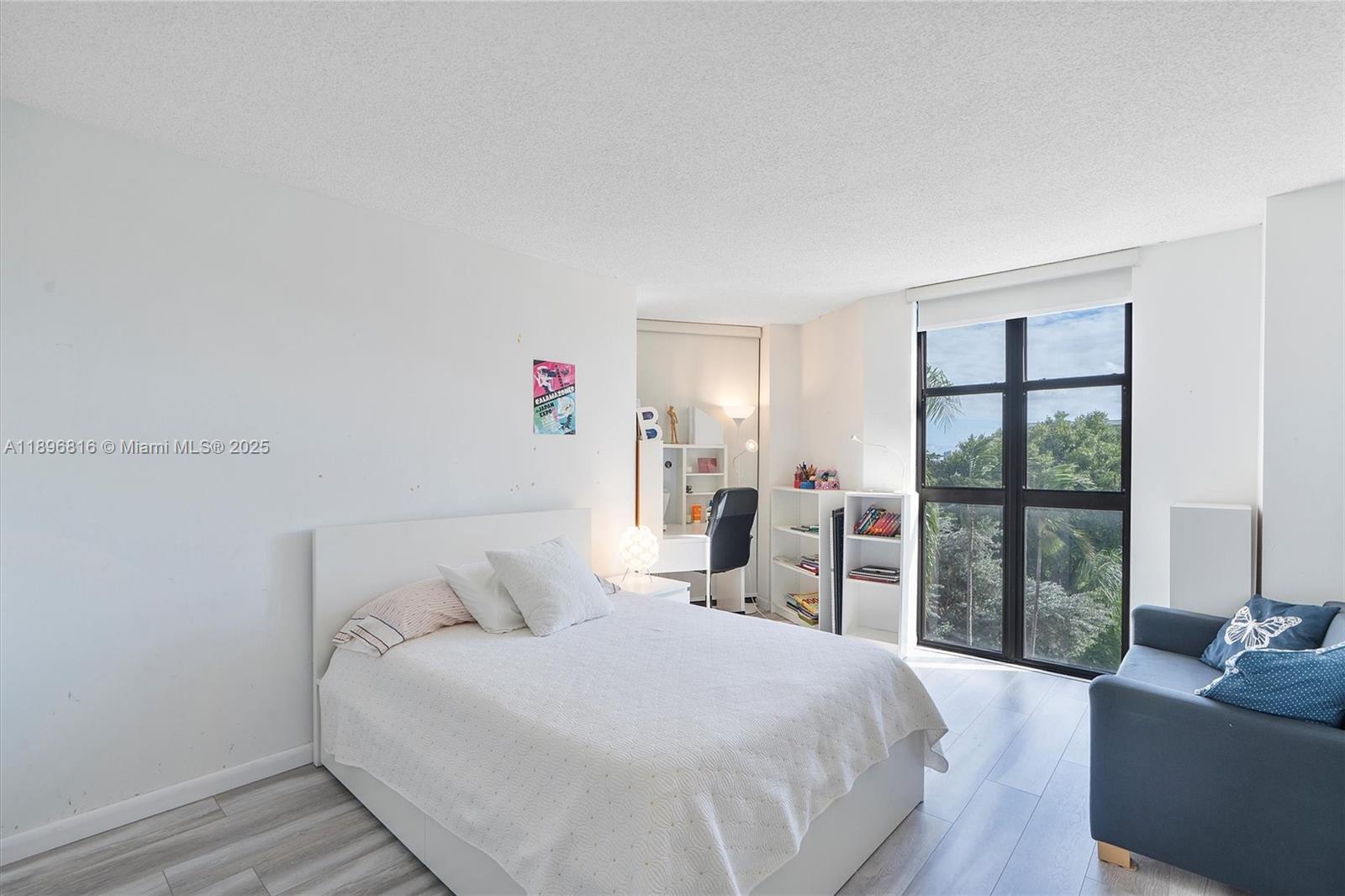 4000 Towerside Terrace, Unit 402 Miami, FL 33138 - Photo 23 of 54 a bedroom with a large bed and a large window