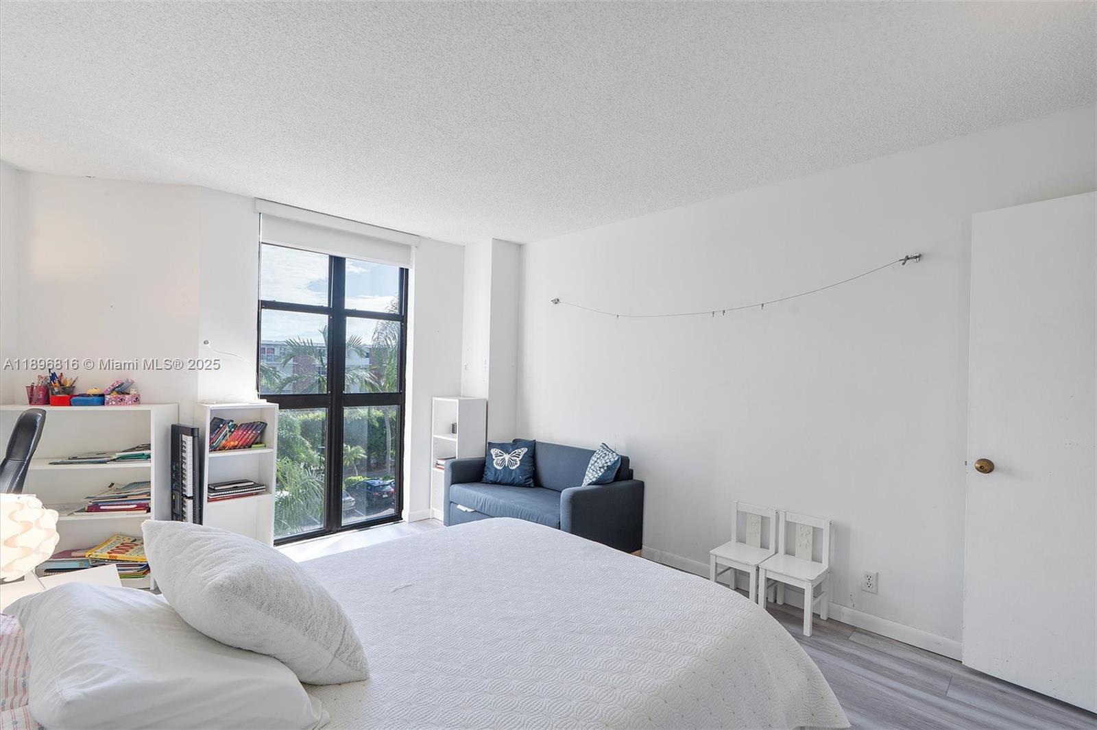 4000 Towerside Terrace, Unit 402 Miami, FL 33138 - Photo 24 of 54 a bedroom with a bed and a window