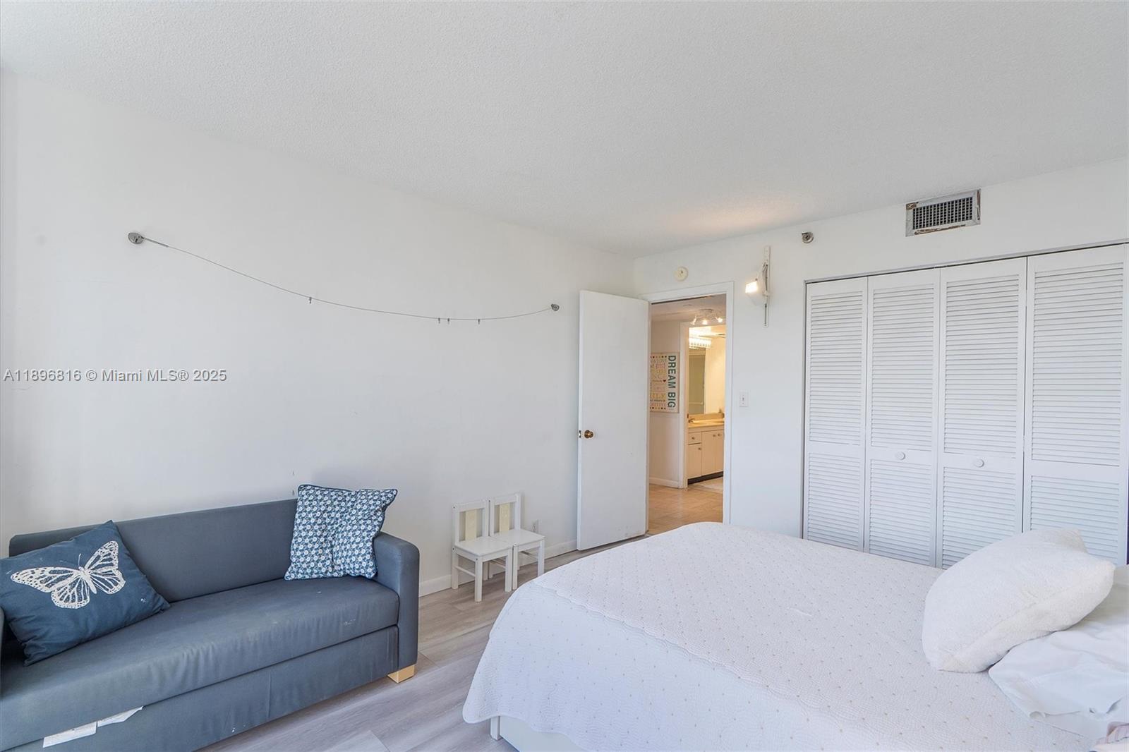 4000 Towerside Terrace, Unit 402 Miami, FL 33138 - Photo 25 of 54 a bedroom with a bed and a couch